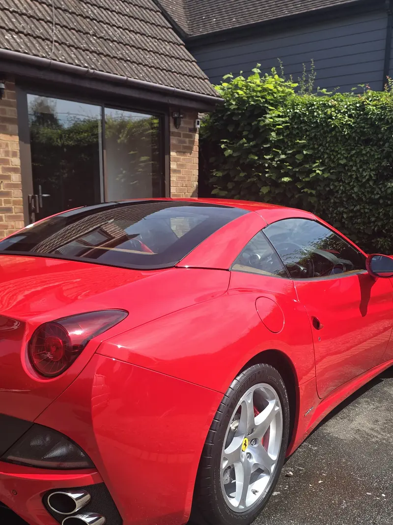 Red Ferrari California photographed on a client driveway