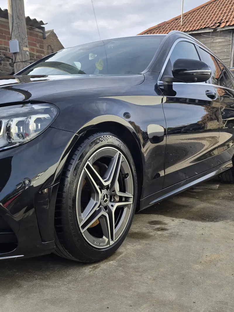 Black Mercedes on a driveway with freshly finished paintwork